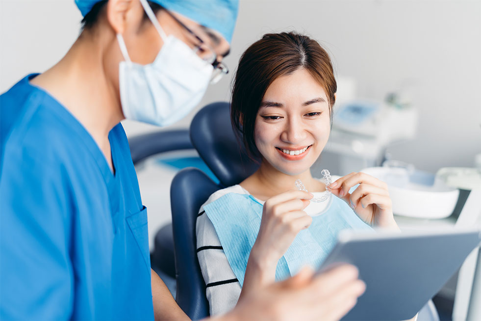 Dentist explaining Invisalign braces