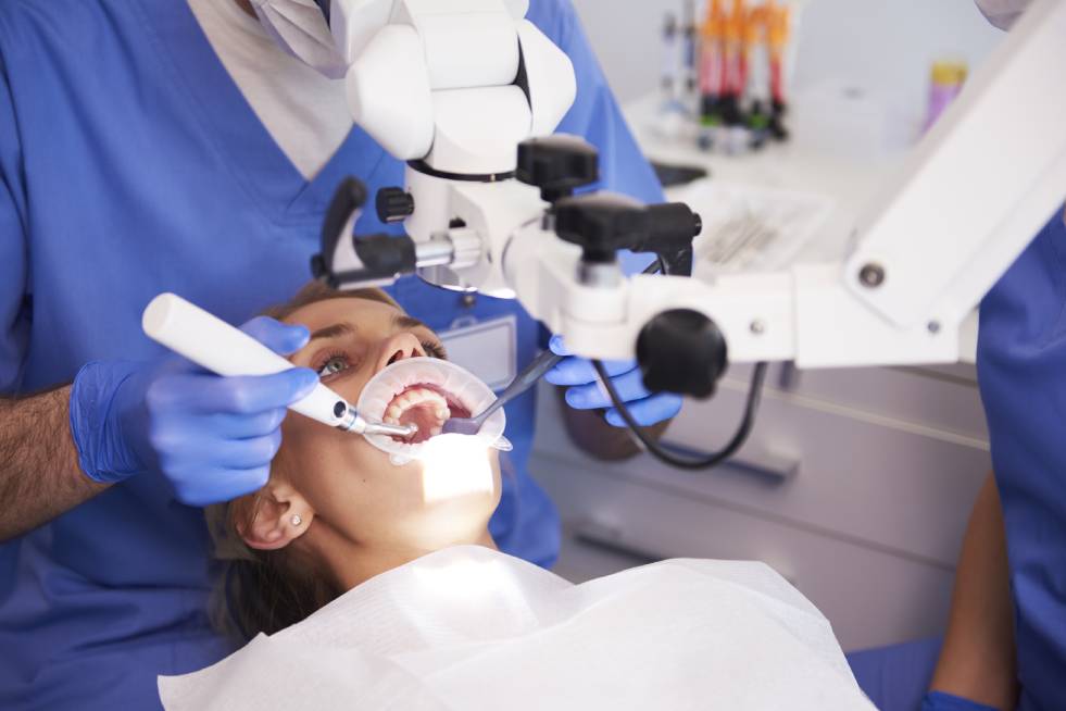 a dentist is treating a patient for root canal treatment