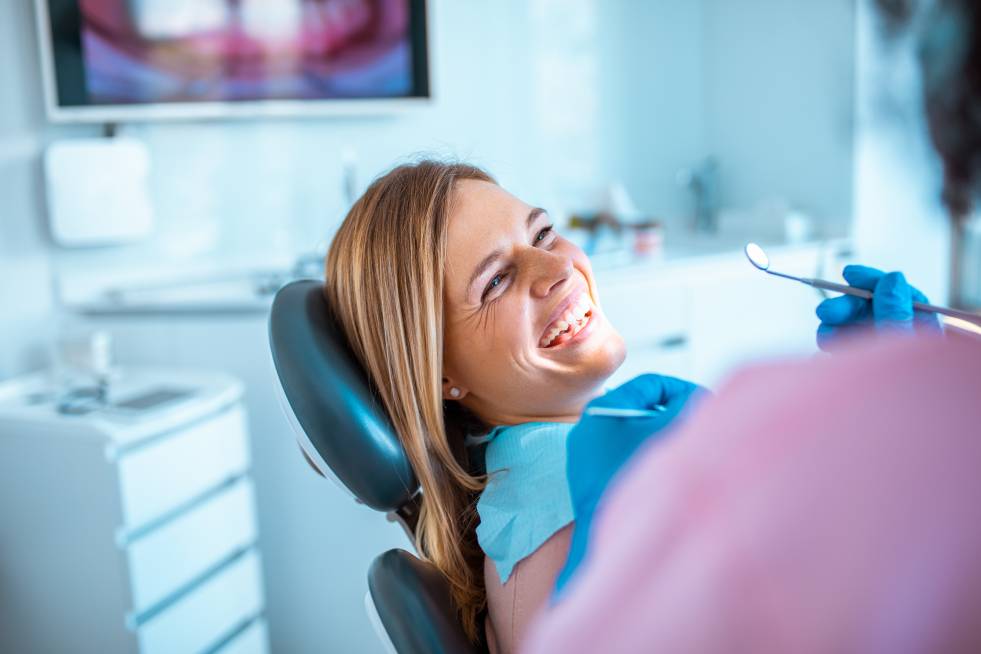 a young lady is getting treated by the dentist