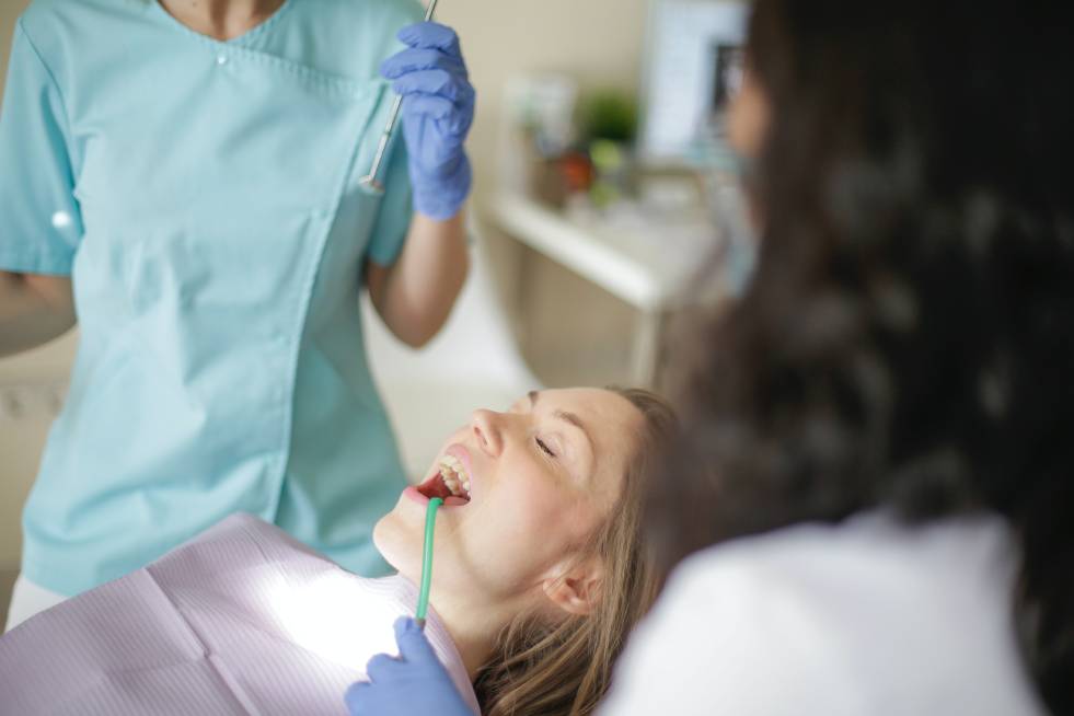 a girl is getting treated at the dentist clinic